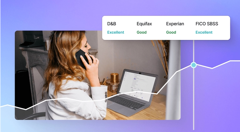 woman on the phone looking at her business finances talking to a business credit coach