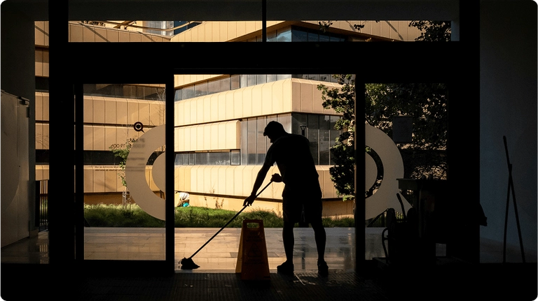 man cleaning in a hall way silouette