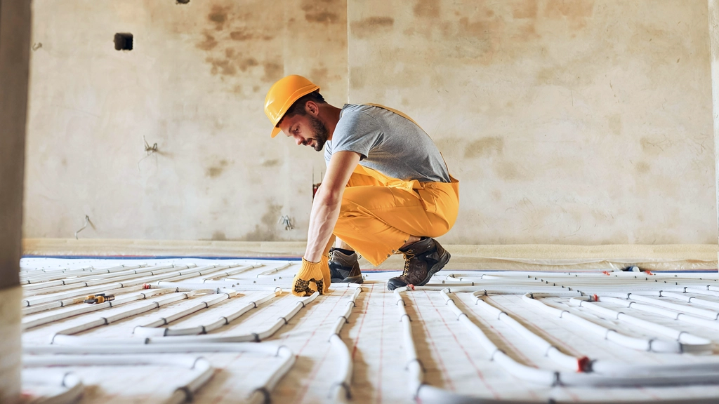 A man prepares a floor for new flooring
