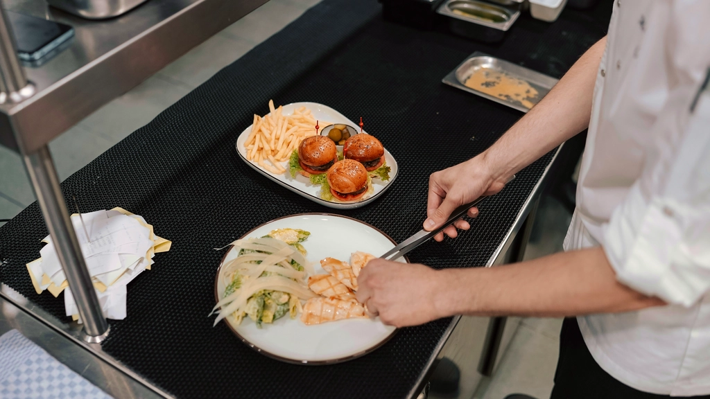 A chef plates a meal