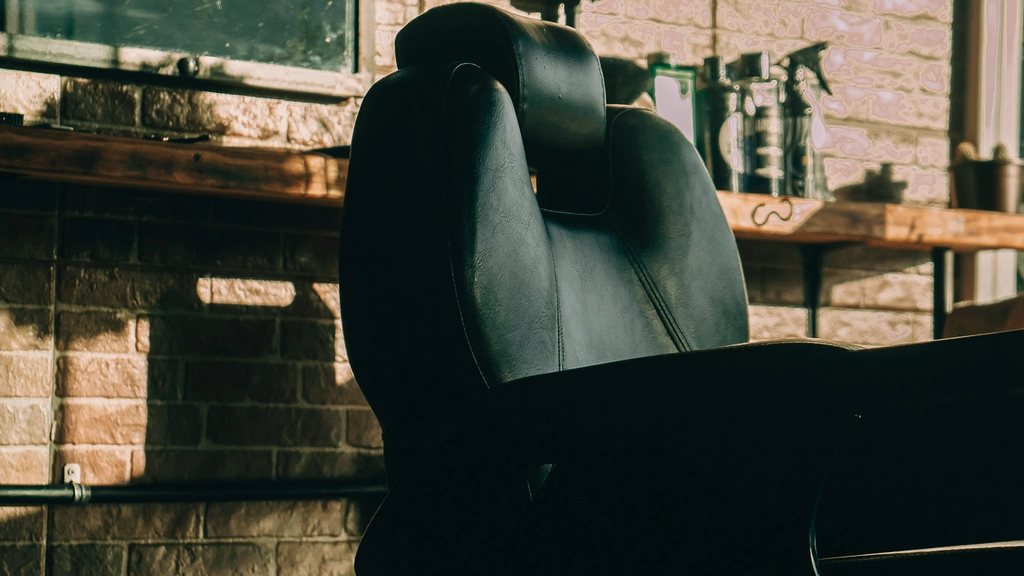 An empty barber chair sits in a salon waiting for the next customer