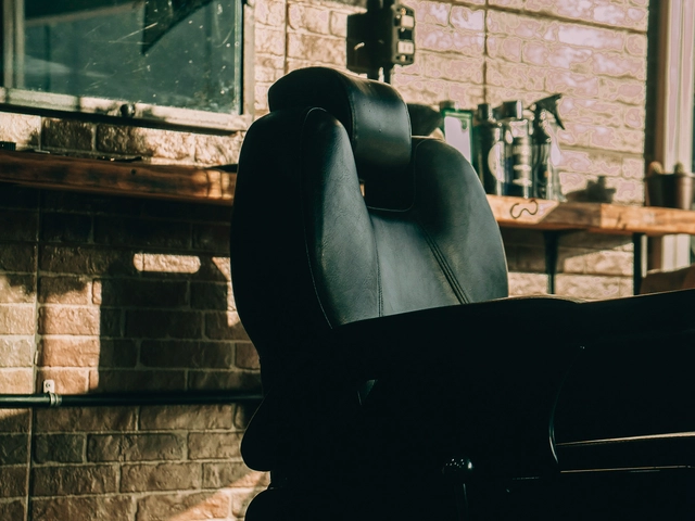An empty barber chair sits in a salon waiting for the next customer