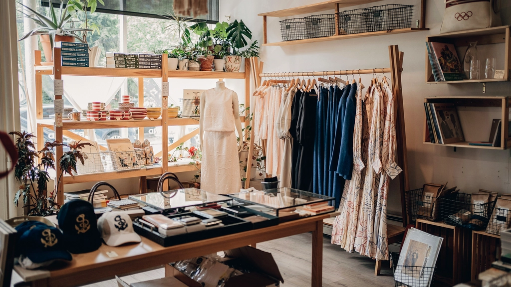 A small apparel showroom with a rack of dresses