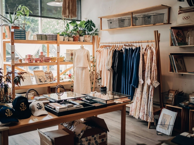 A small apparel showroom  with a rack of dresses