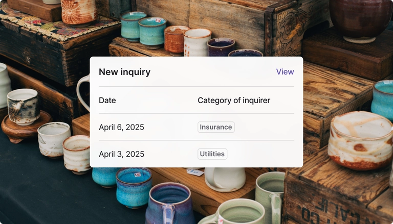 A widget showing a new inquiry for business credit scores overlayed over pottery work