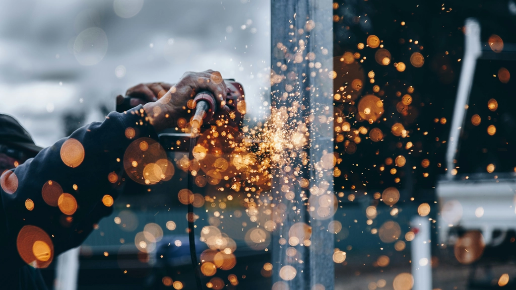 Hands and an unfocused image of sparks flying