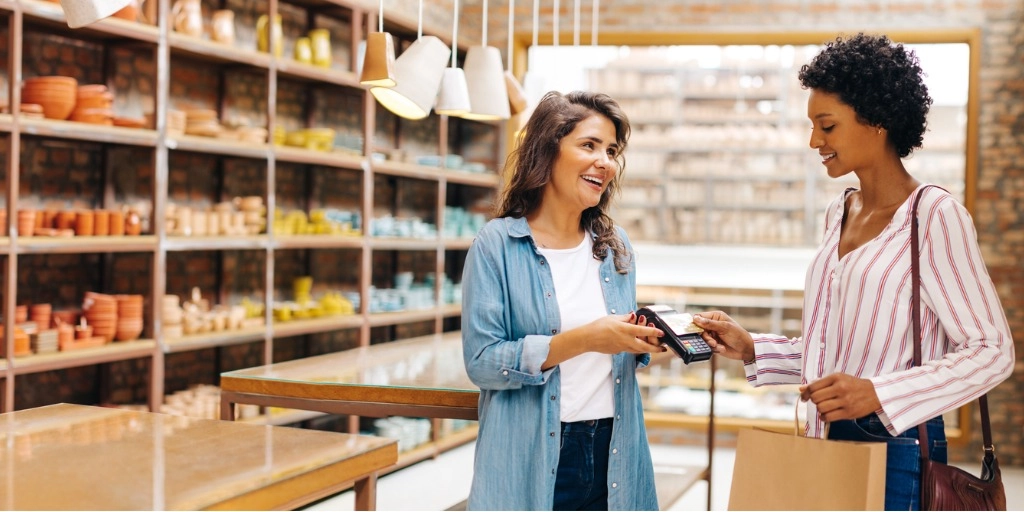 Woman using Arro mastercard to make a purchase at a small business