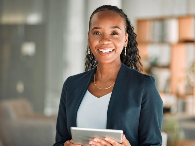 young woman professional in casual suit holding tablet to illustrate article about business credit starter pack