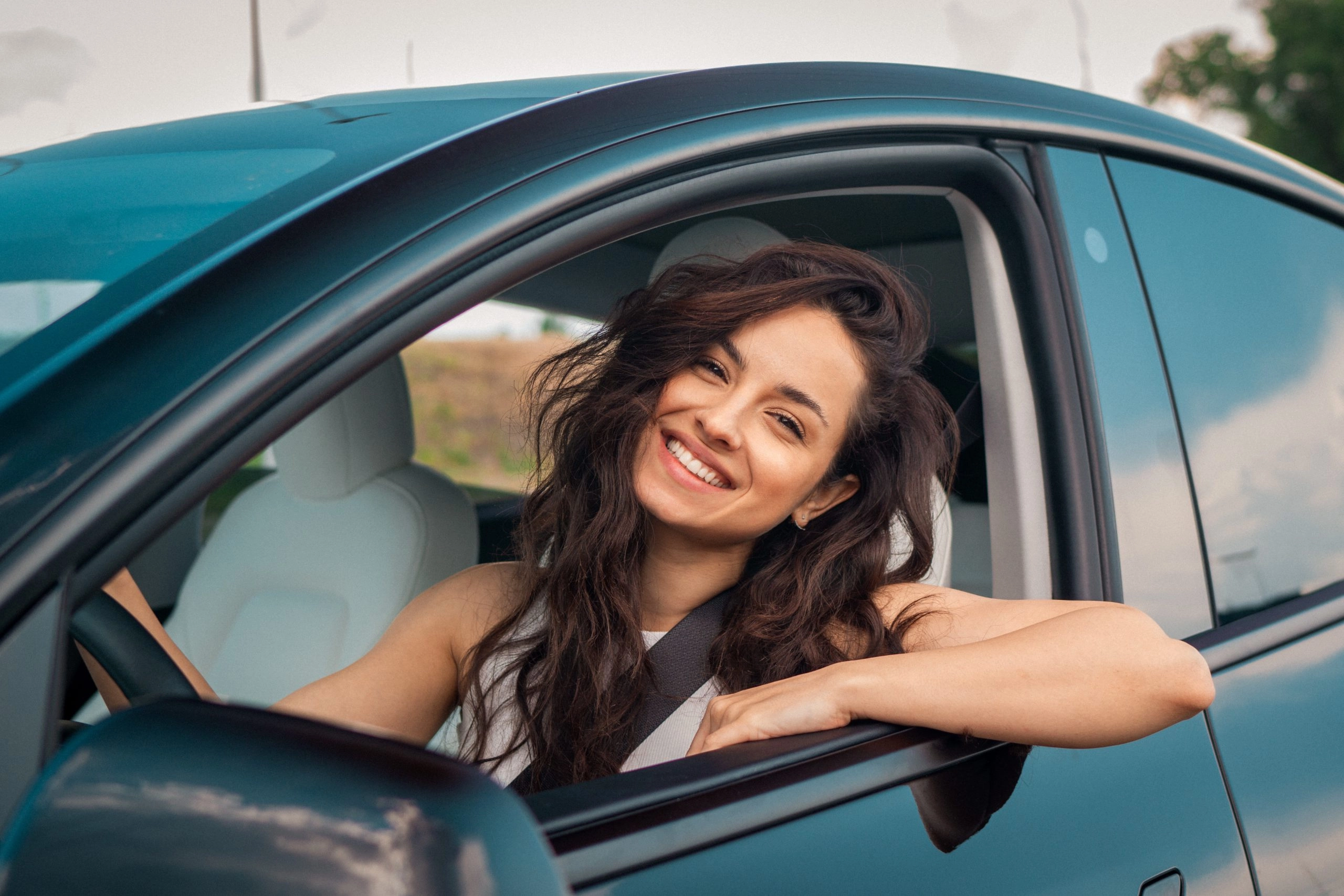 woman driving car with employee auto insurance