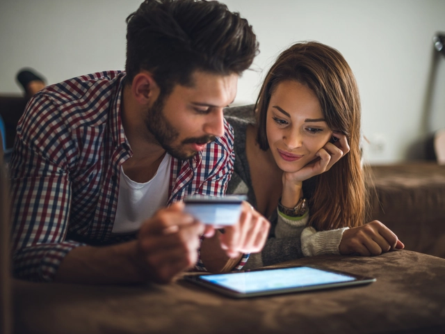 Couple looking at tablet device reviewing small business loan brokers