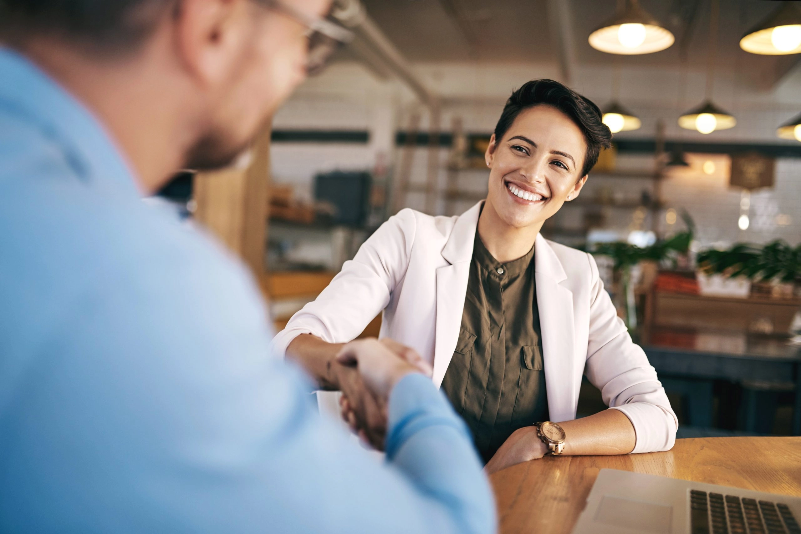 business owner shaking hands acquiring a business
