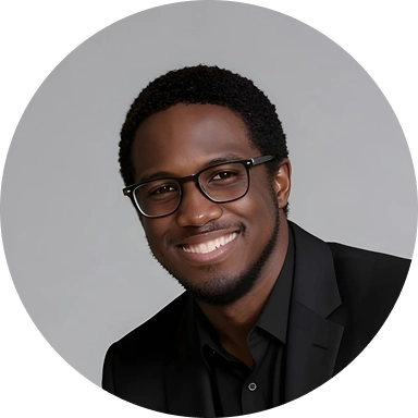 Circular profile photo of a smiling man wearing glasses and a black suit against a gray background.
