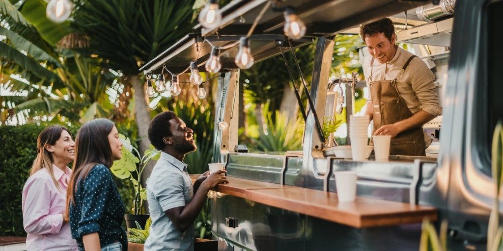 Food truck owner serving three customers