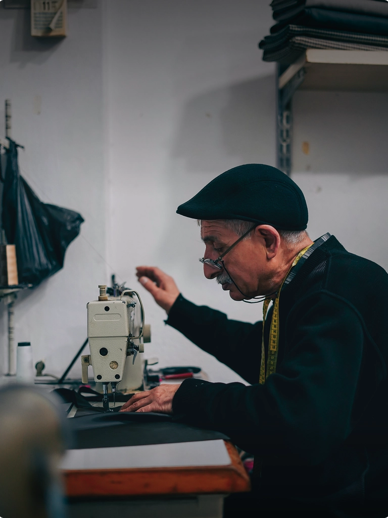 business owner working through hemming some pants