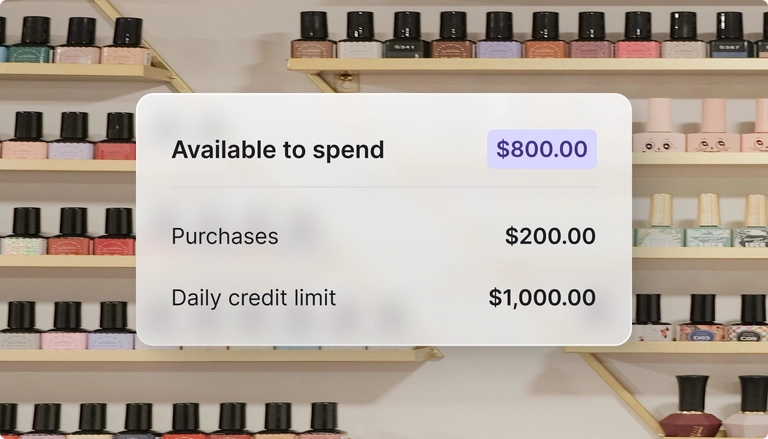 Available spending amount displayed on the screen with a nail polish rack in the background