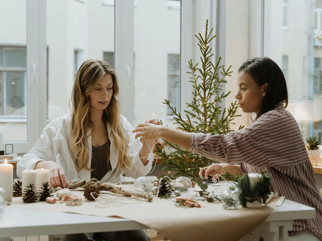 Two female business owners working at a table with holiday decor to illustrate article about preparing a business for the holidays