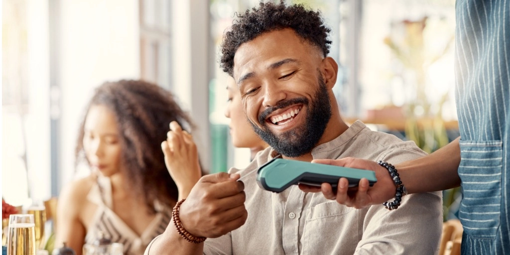 Customer paying with a credit card at a restaurant